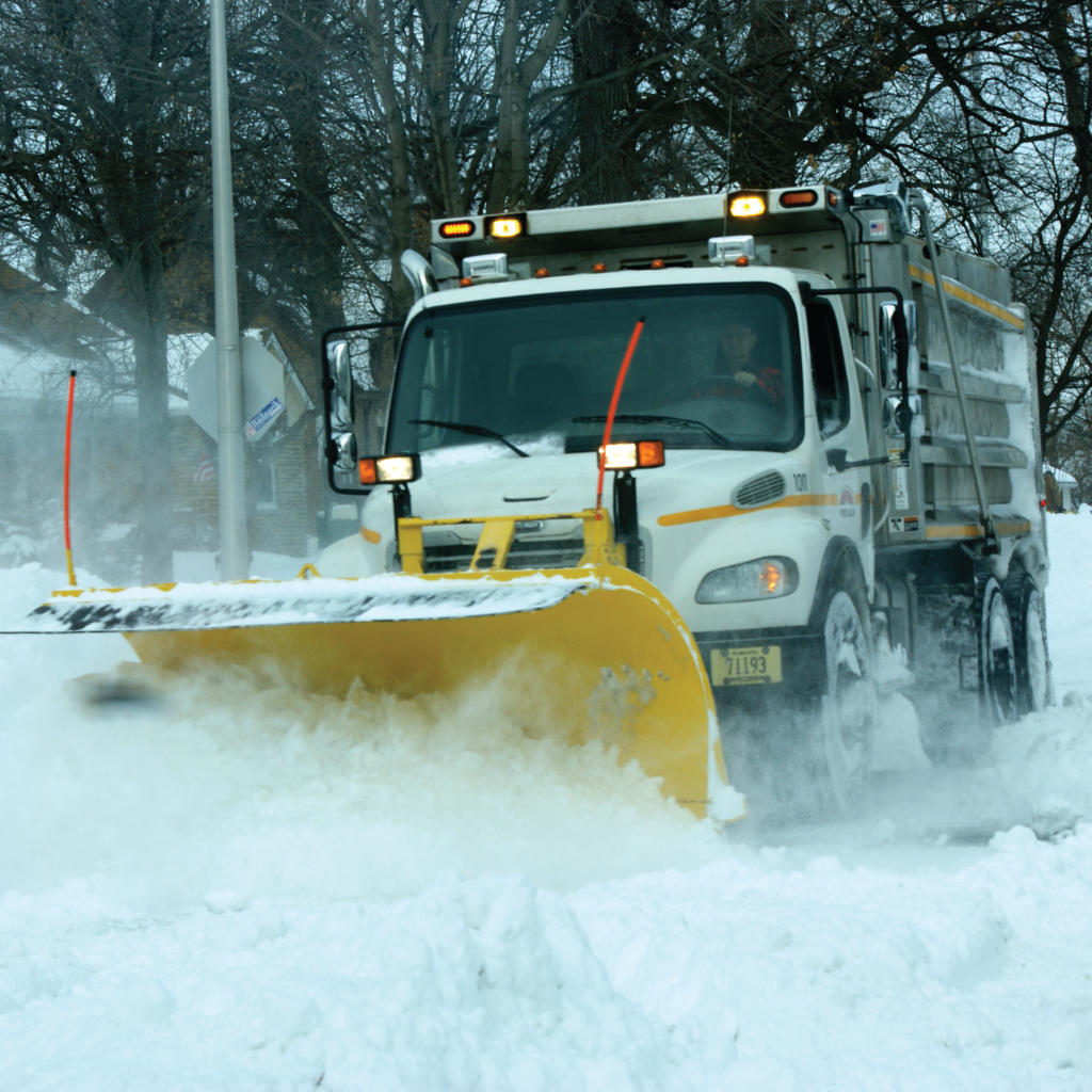 A photo of a West Allis snow plow pushing snow.