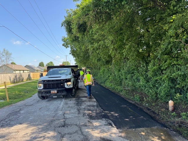 Images of public works staff working on repairs to South Hunt Road