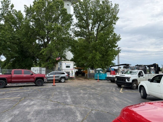 Work crews and a Viking work trailer at the base of the water tower