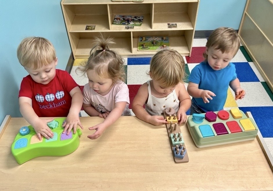 4 kids playing with table toys
