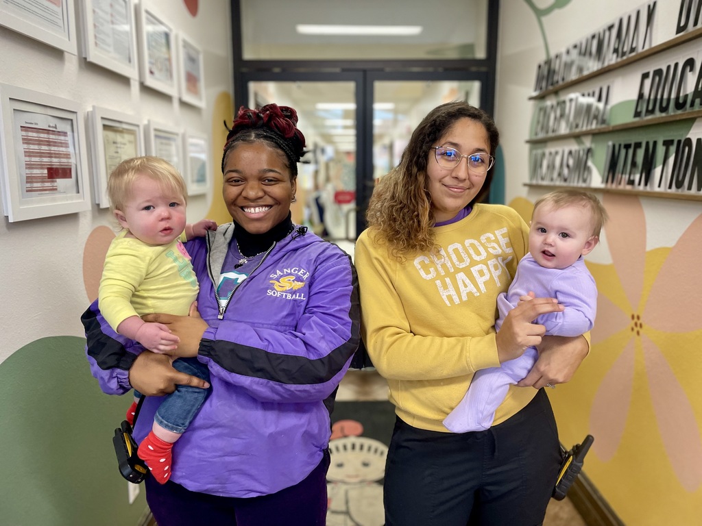 Purple and Yellow dressed teachers and babies
