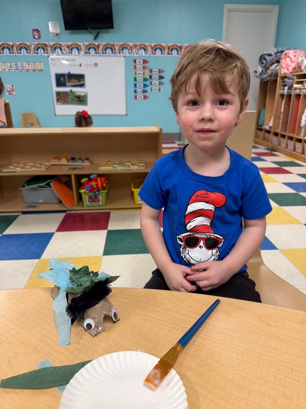 little boy showing off his created bug