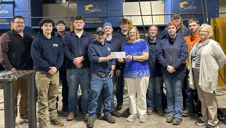 Welding Class receiving check from Art Walk Committee for winning in Art contest.