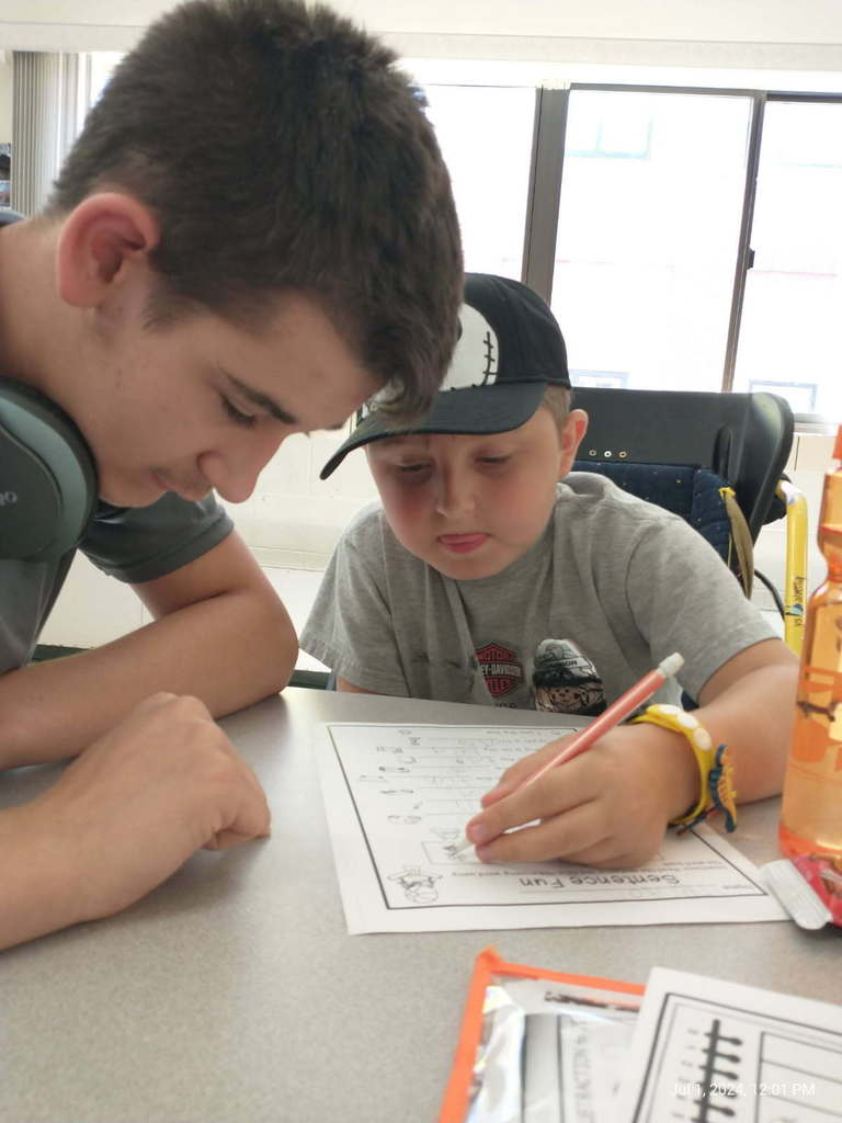Glad, one senior high ignite student helps sparks student with homework.