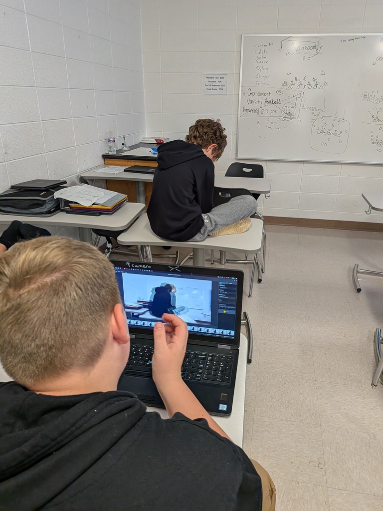 A student animating another student rotating on a table.