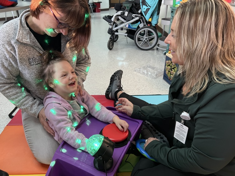 a student uses a Big Mac switch to activate a light