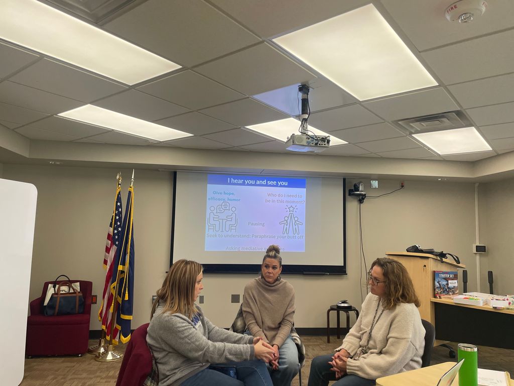Three instructional coaches having a coaching conversation.