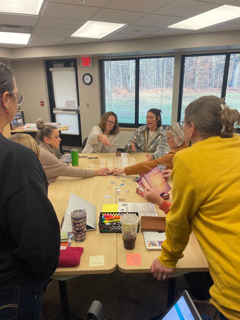 Adults around a table playing a game.