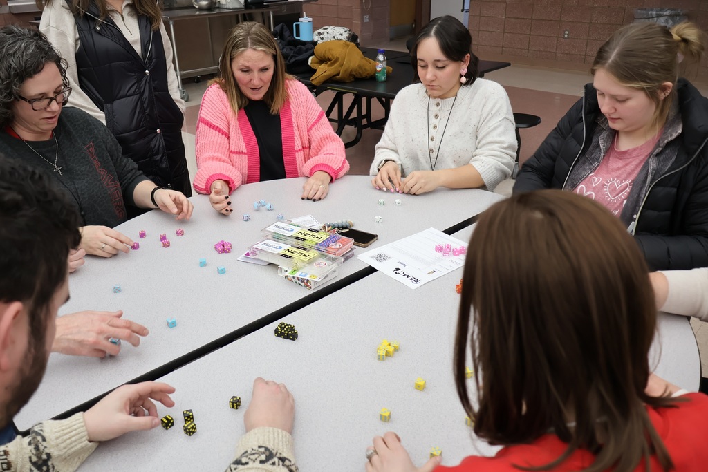 Teachers play a game with dice.