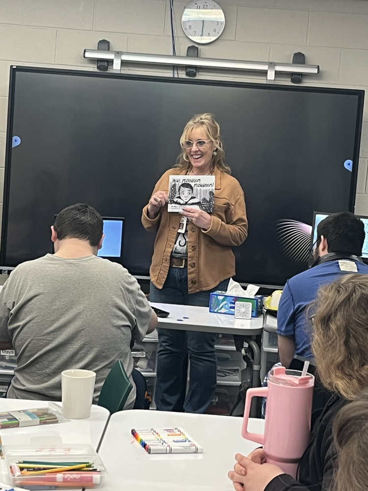 Molly reading her book to Area School Students