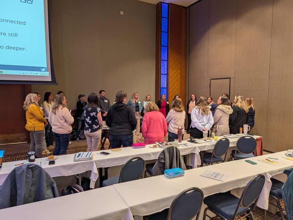 A groups of instructional coaches discussing the roles and responsibilities of being coaches. 