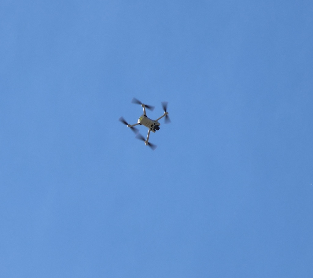 A drone high in the air.