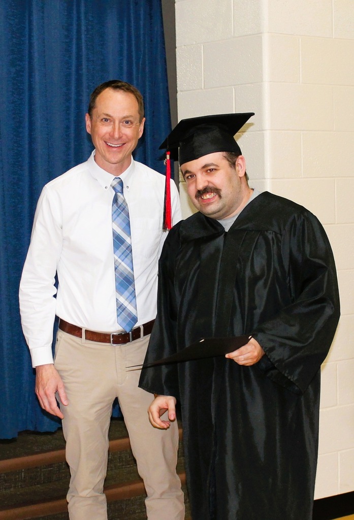 Graduate getting his certificate with Mr. Simon, Superintendent 