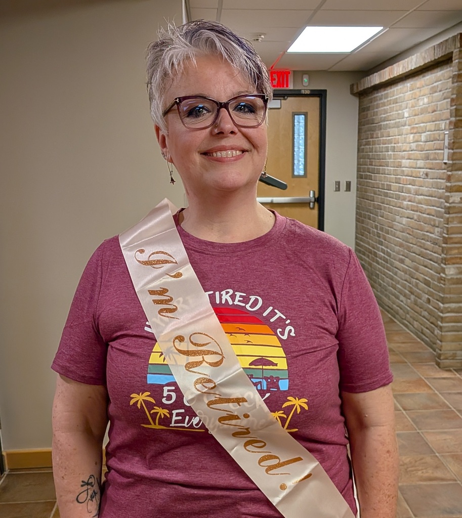 Stacey Beebe wearing a festive sash that says "I'm retired!"