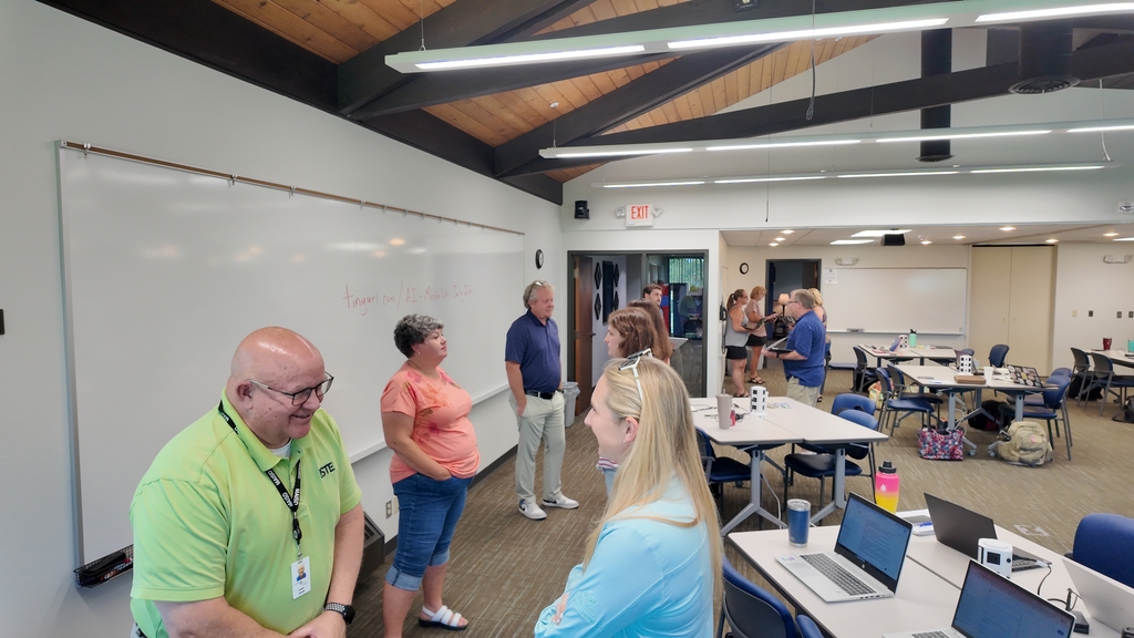 Educators pair up to discuss their plans for AI in their classrooms and schools.