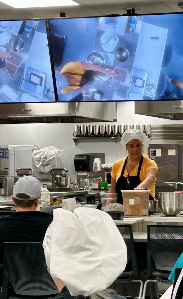 Culinary Arts Instructor showing students how to make brownies