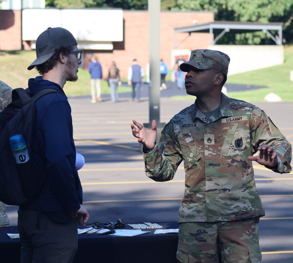 Student speaking with U.S. Army representative at Senior Focus Day.