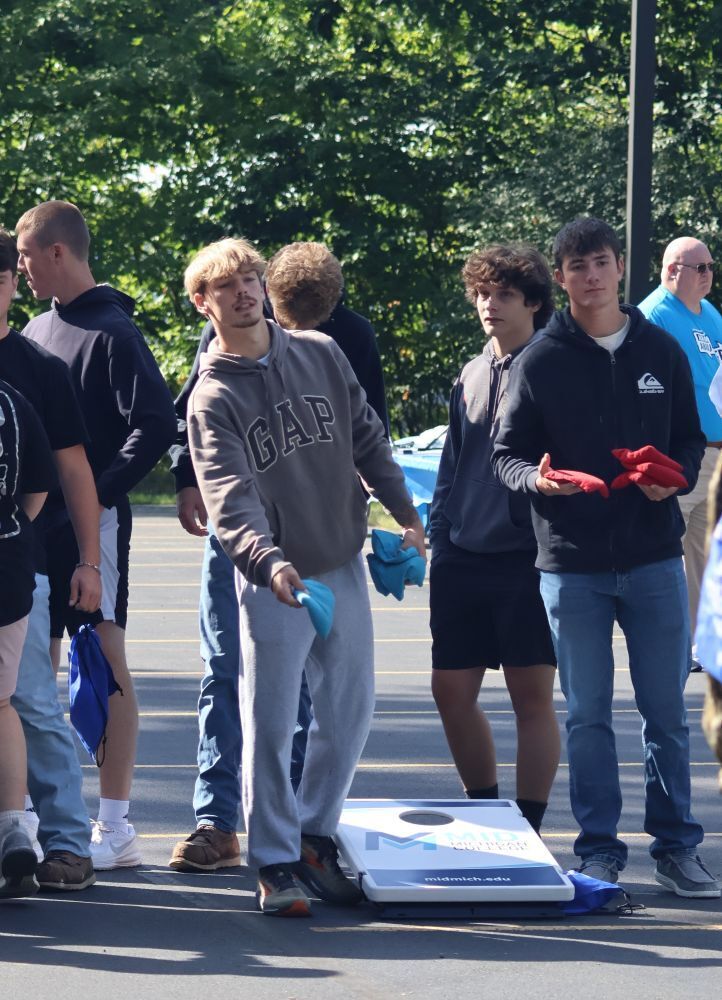 Student playing cornhole at Senior Focus Day.