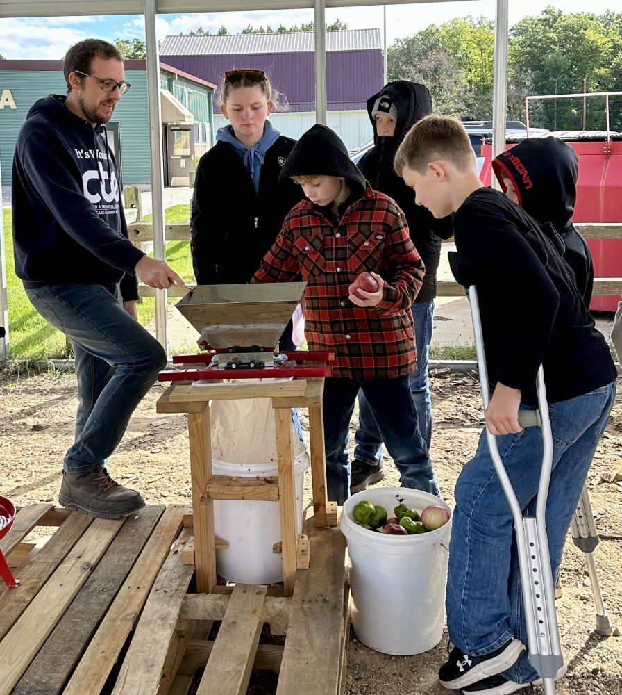 Students learning how to make cider