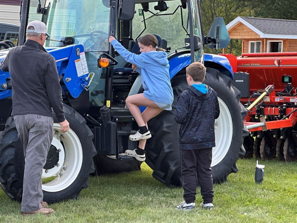 Student climbing in tractor