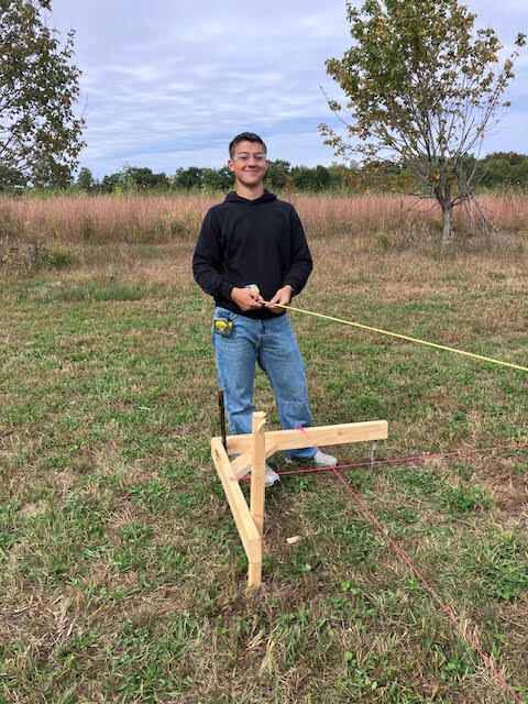 Construction Trades student setting strings.