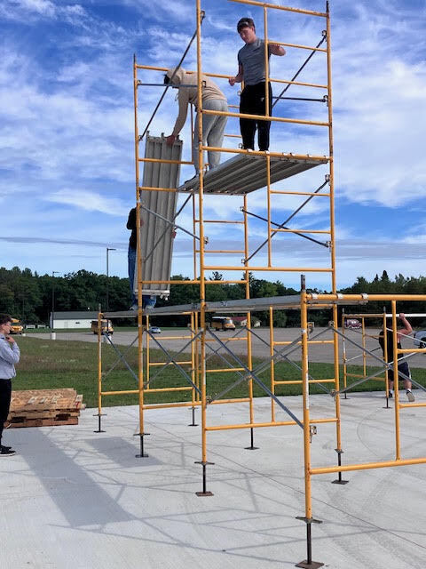Construction Trades students setting up scaffolding.