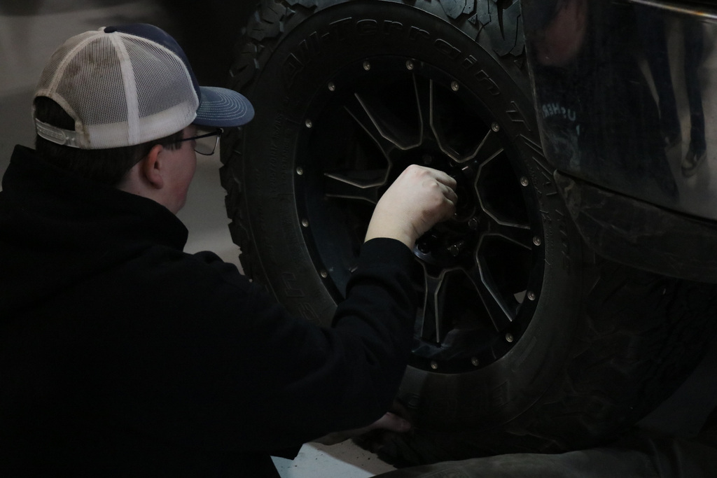Student checking air in tires