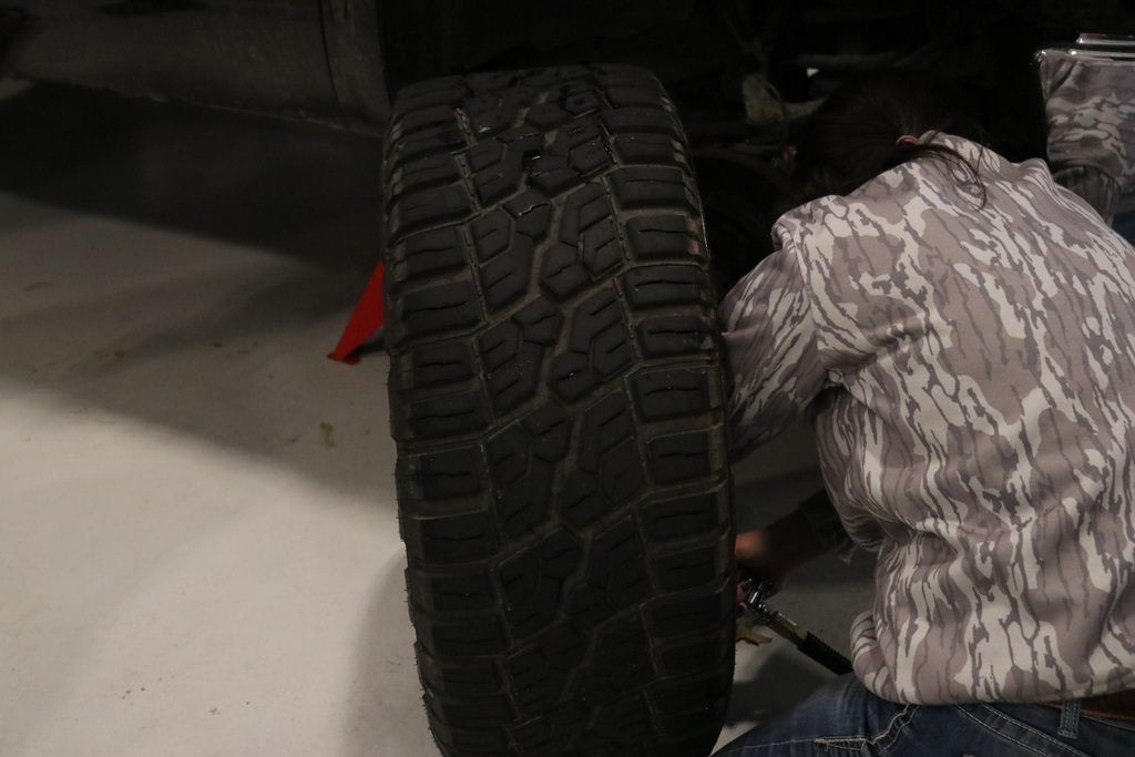 Student adding air to tires