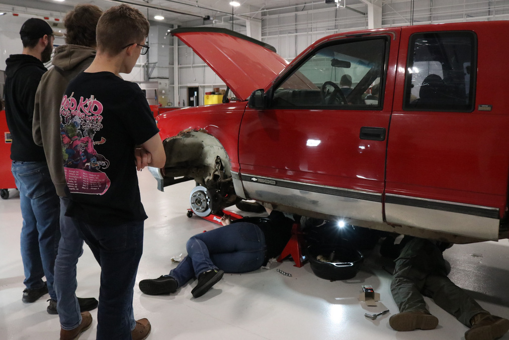 Students working under a car