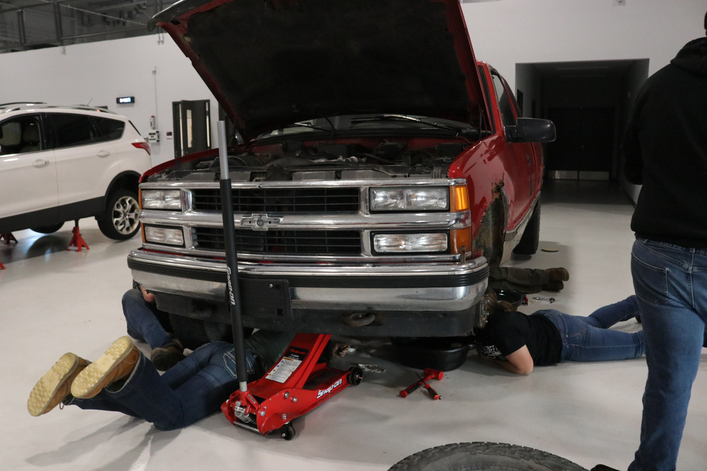 Students working under a car