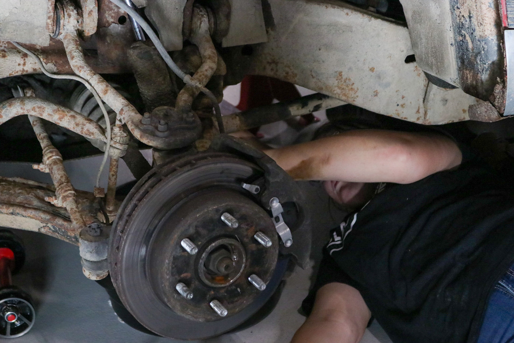 Student working under a car