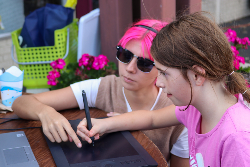 Student helping kid animate