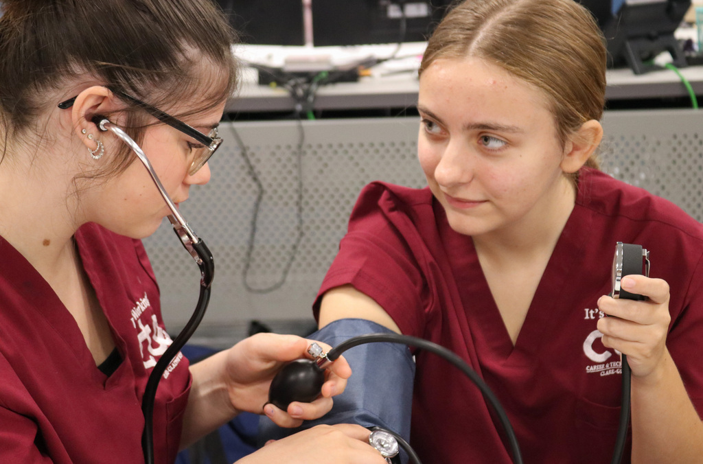 Student taking another students blood pressure