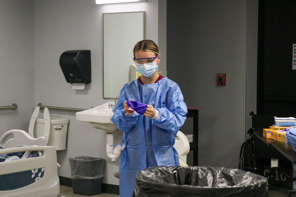 Students putting on personal protective equipment