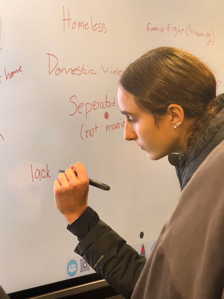 Student writing a learning barrier on a whiteboard
