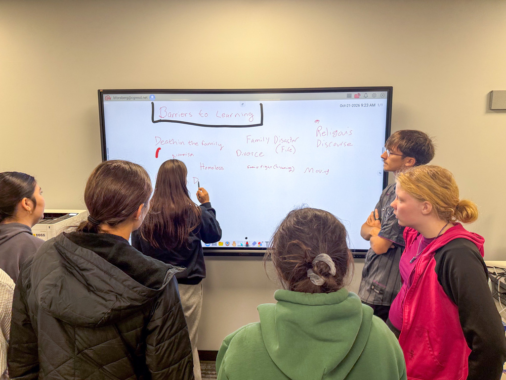 Student writing a learning barrier on a whiteboard