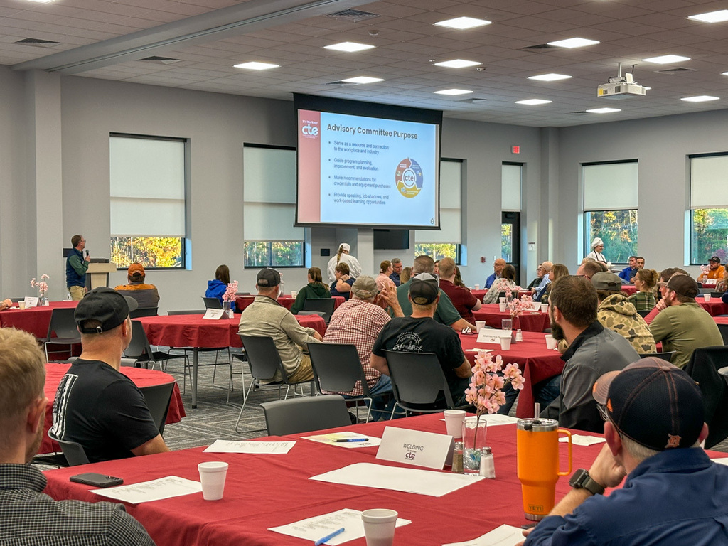 Large group of people listening to an overview of the advisory meeting