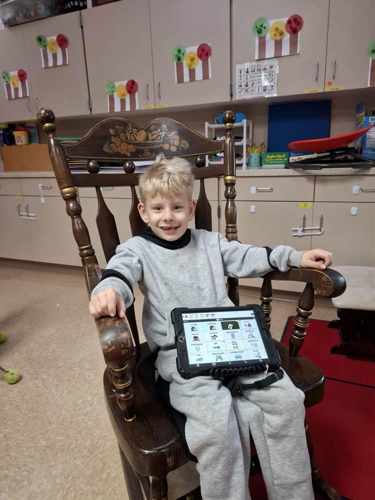 Male student using AAC device