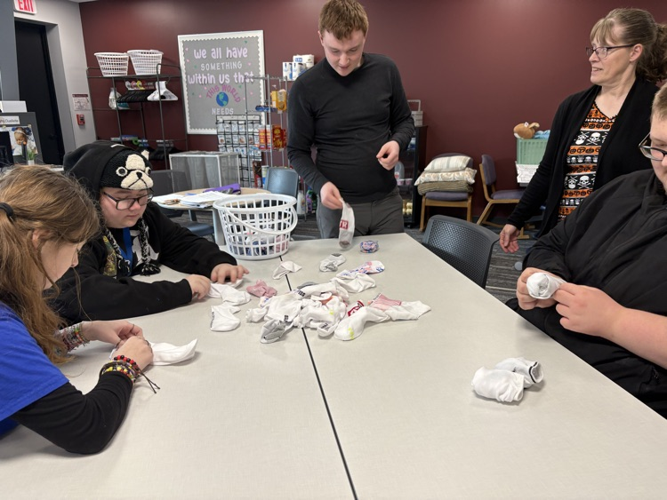 Students working together to match and fold socks