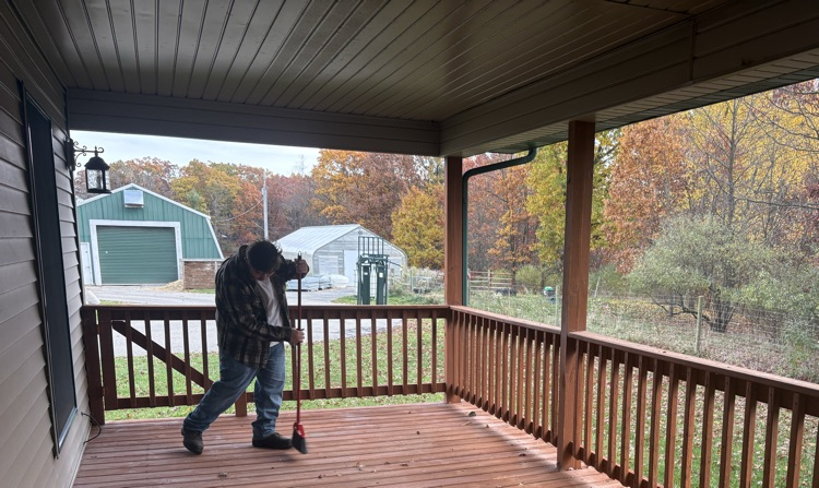 Sweeping the fall leaves of Verna’s house patio