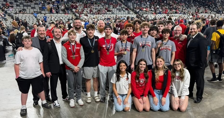wrestlers with medals and coaches