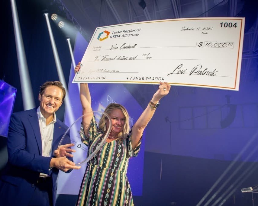 vona with award and big check on stage