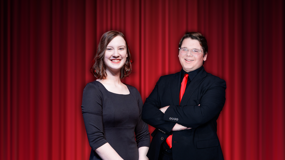two students in front of curtin in black 