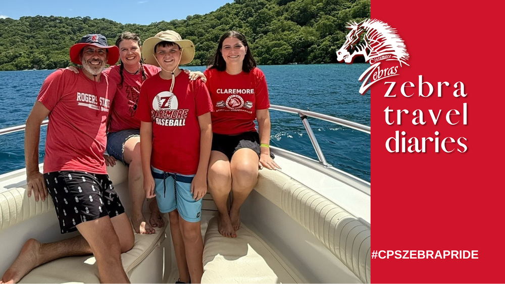 family with claremore logo shirts in a boat 