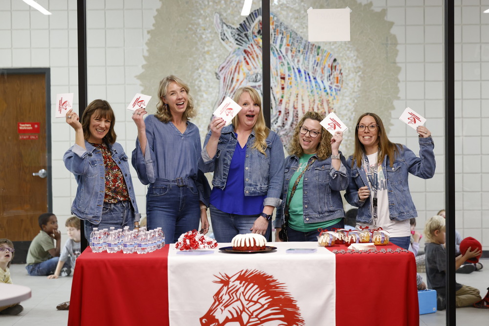teachers holding up cards