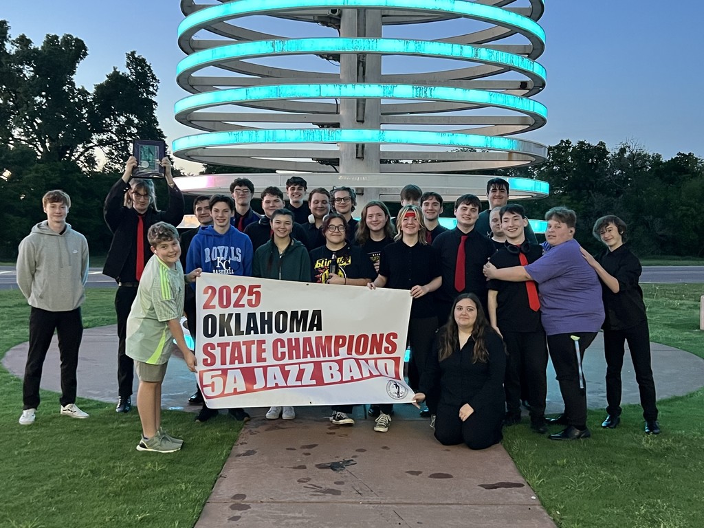 band members with state championship sign 