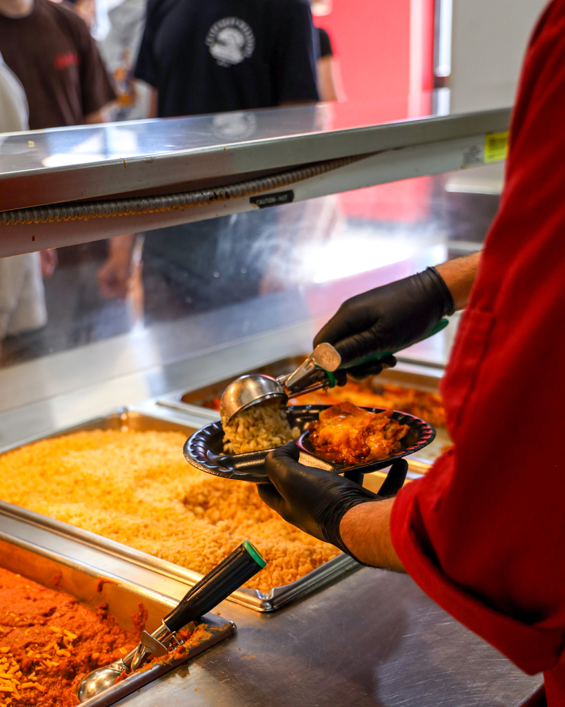 Chef Ryan serving students Enchilada