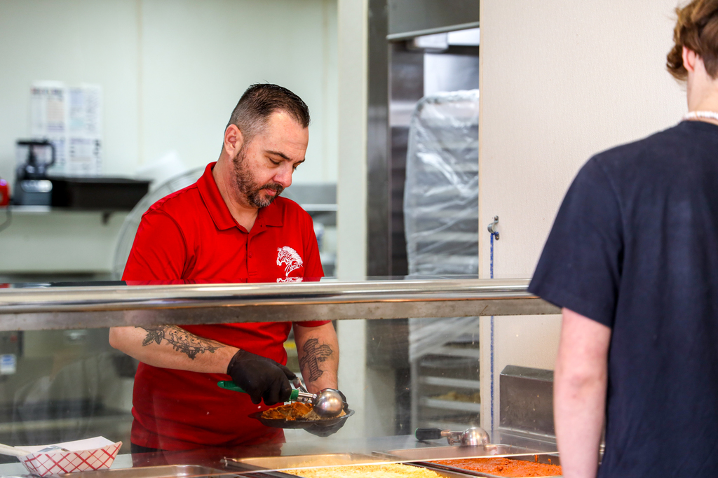 Chef Ryan serving students Enchilada
