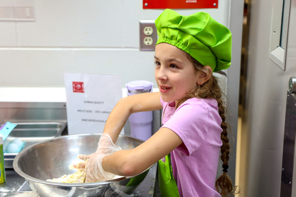 Junior Chef working on her dish