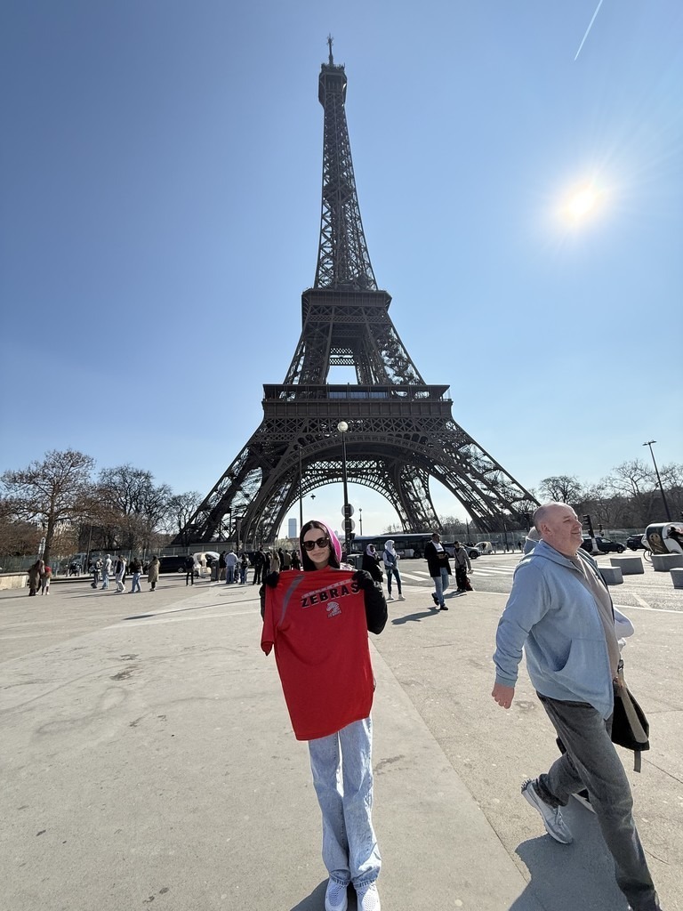 CPS Student in front of the Eiffel tower.